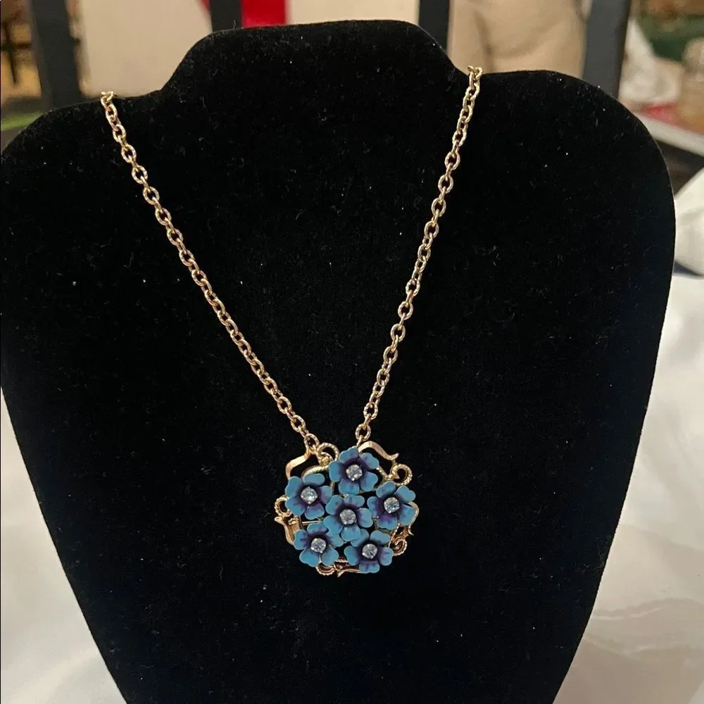 Vintage Avon blue flower pendant or broach on a gold colored chain EVC